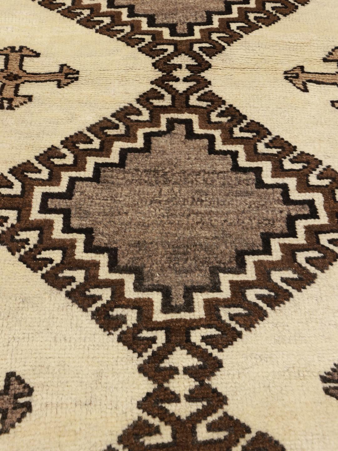 A hand-knotted Shiraz rug from the Middle East featuring geometric patterns in brown and beige.