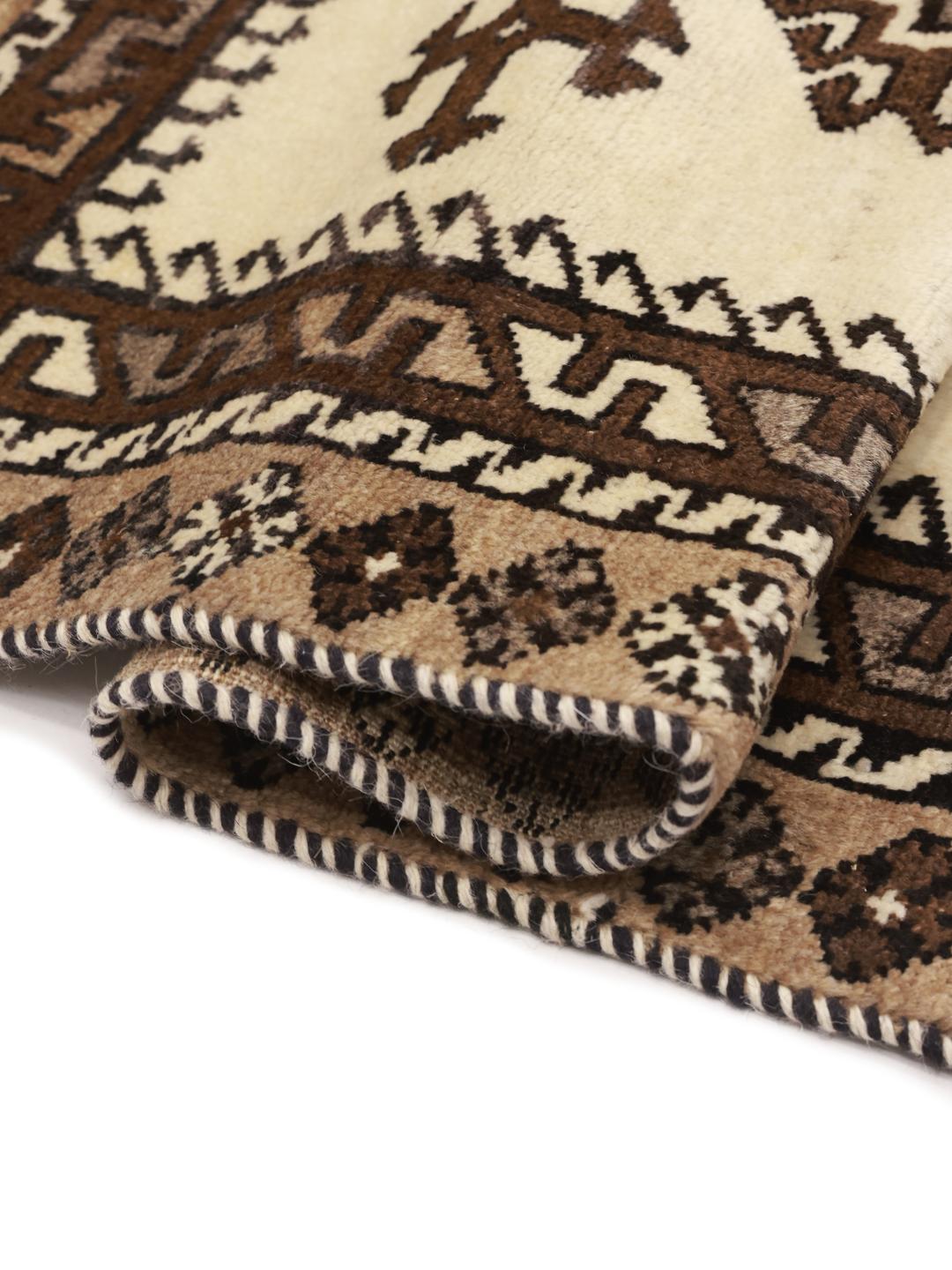 A hand-knotted Shiraz rug from the Middle East featuring geometric patterns in brown and beige.