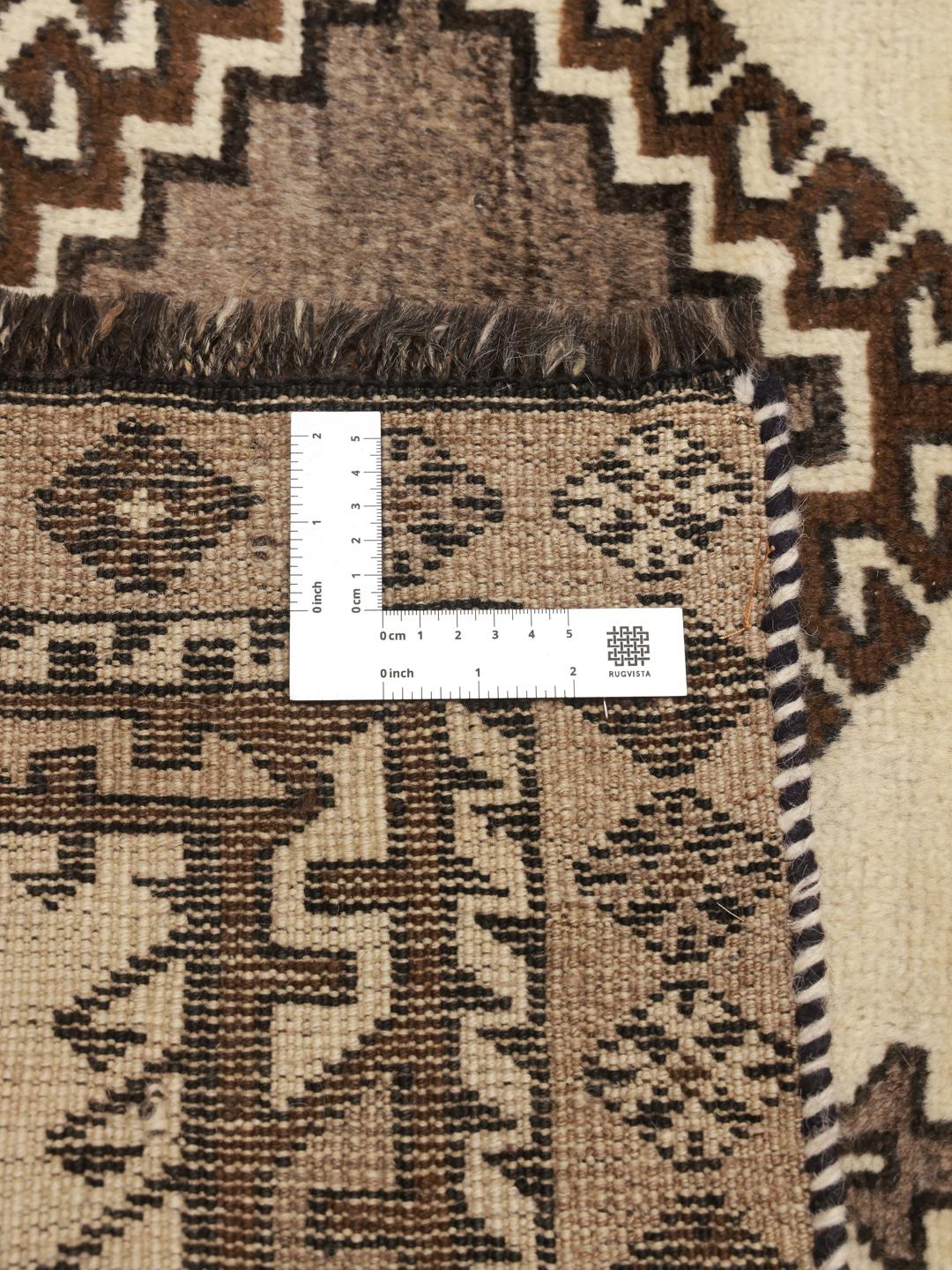 A hand-knotted Shiraz rug from the Middle East featuring geometric patterns in brown and beige.