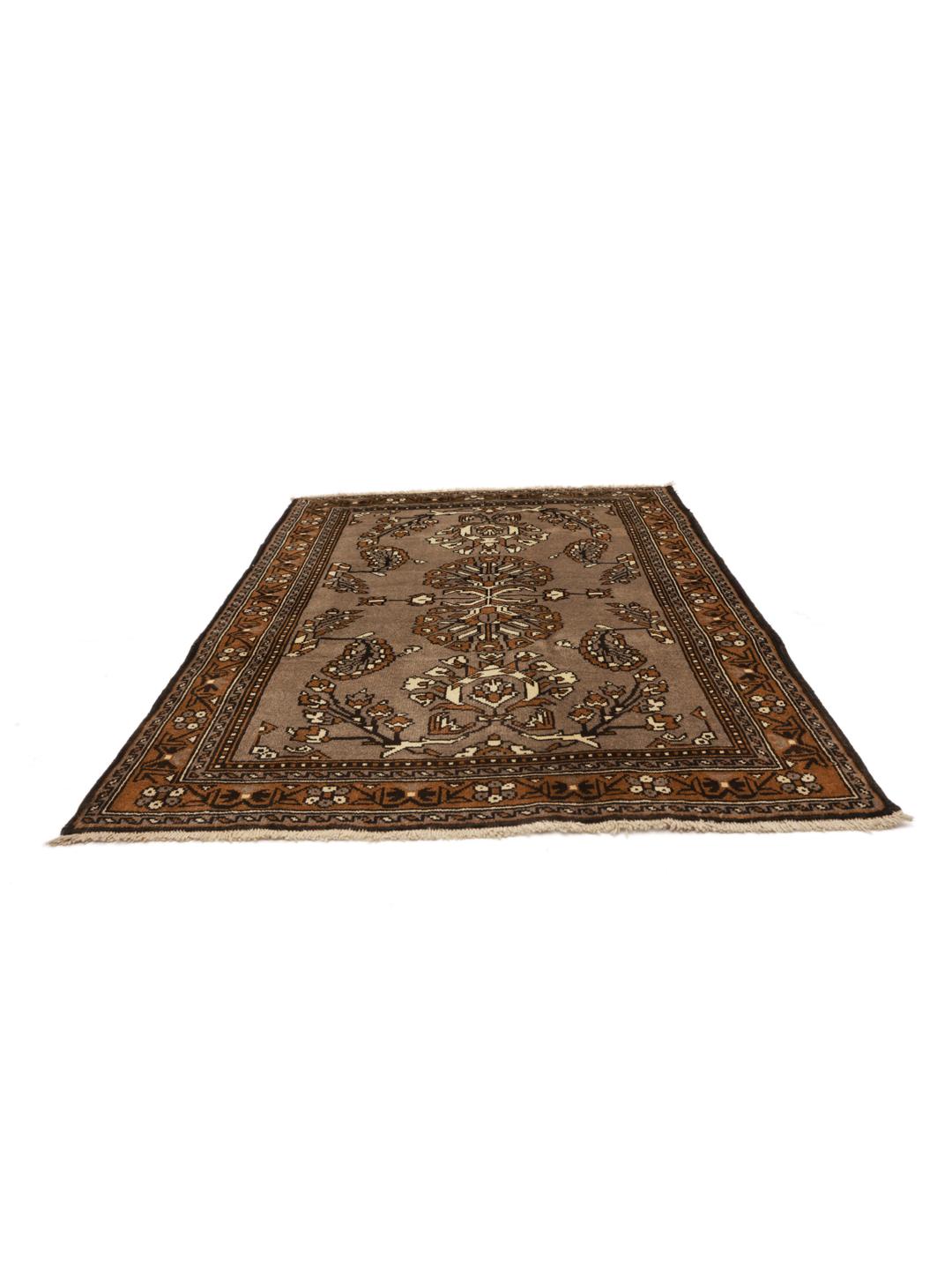 A hand-knotted Shiraz rug from the Middle East featuring brown floral motifs.