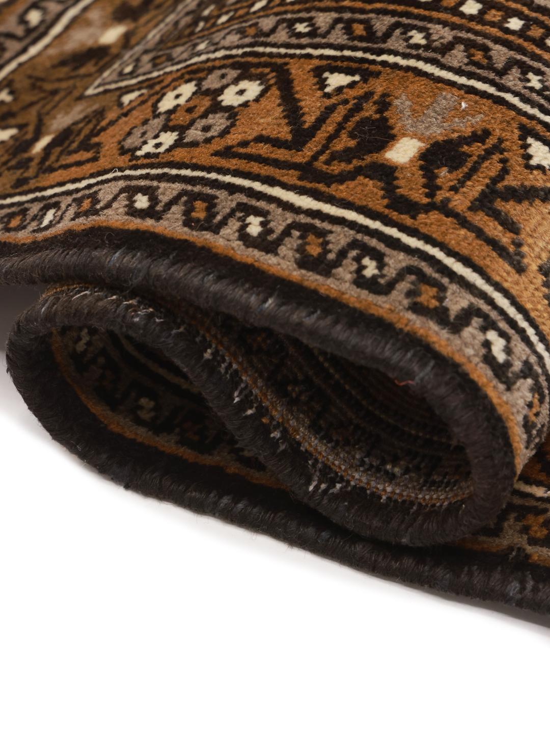 A hand-knotted Shiraz rug from the Middle East featuring brown floral motifs.