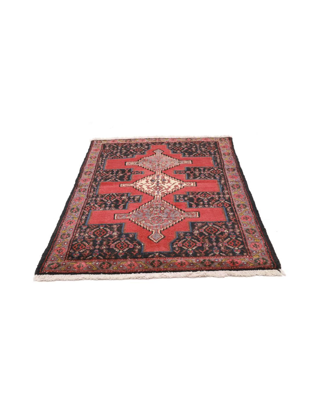 A hand-knotted Senneh rug from the Middle East with a bold red and black geometric design.