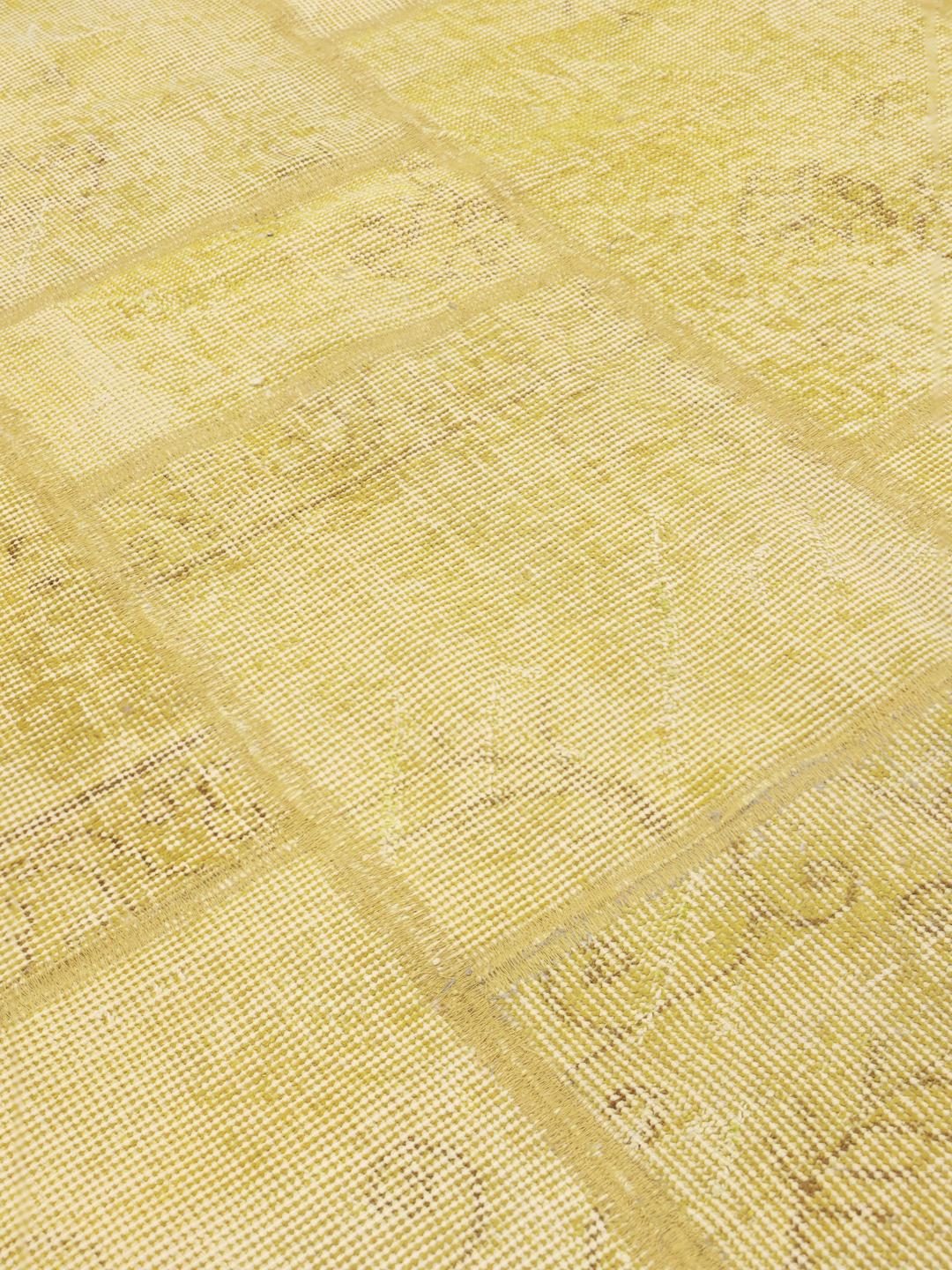 A unique patchwork rug from the Middle East in a soft yellow tone