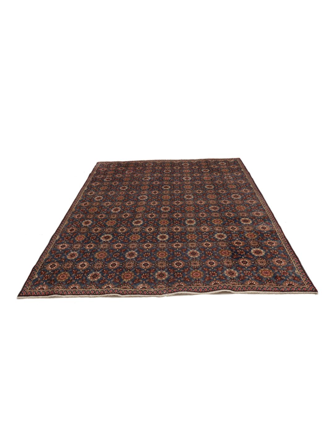 Hand-knotted Sarouk rug from the Middle East featuring a blue field with floral motifs.
