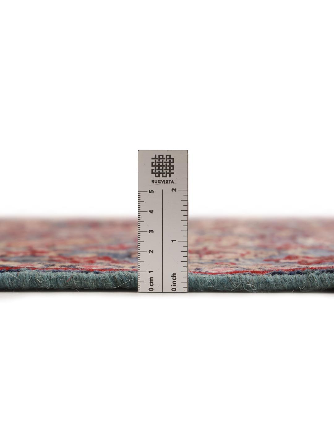 Hand-knotted Sarouk rug from the Middle East featuring a blue field with floral motifs.