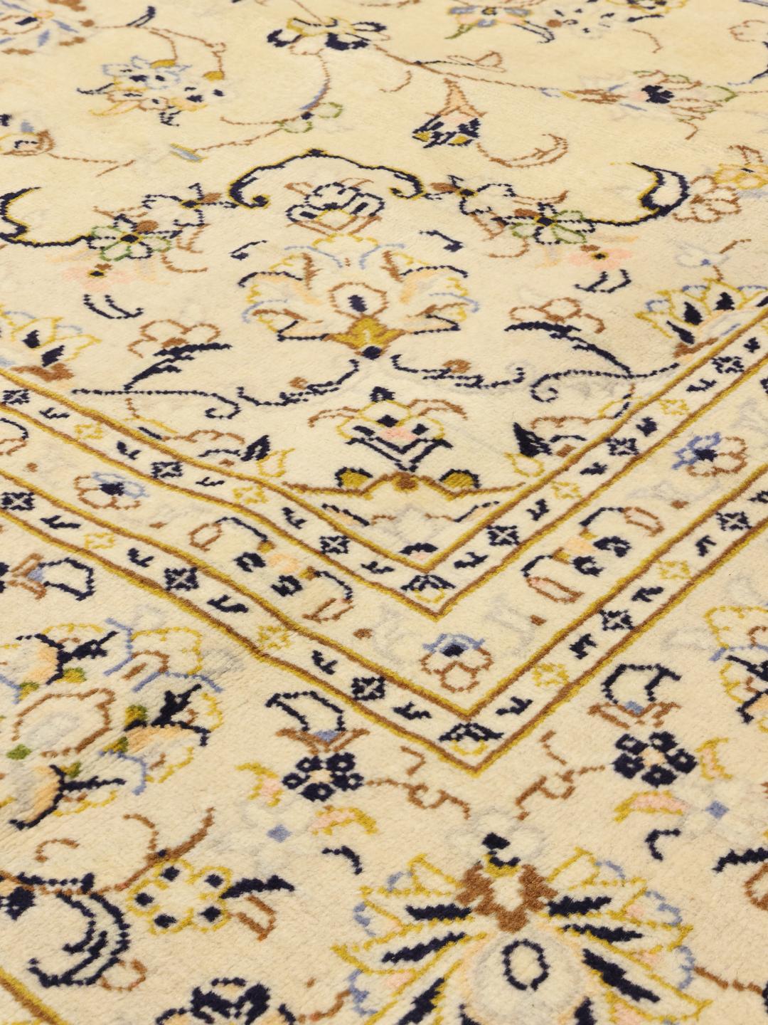 Hand-knotted Keshan rug from the Middle East featuring a beige floral design.