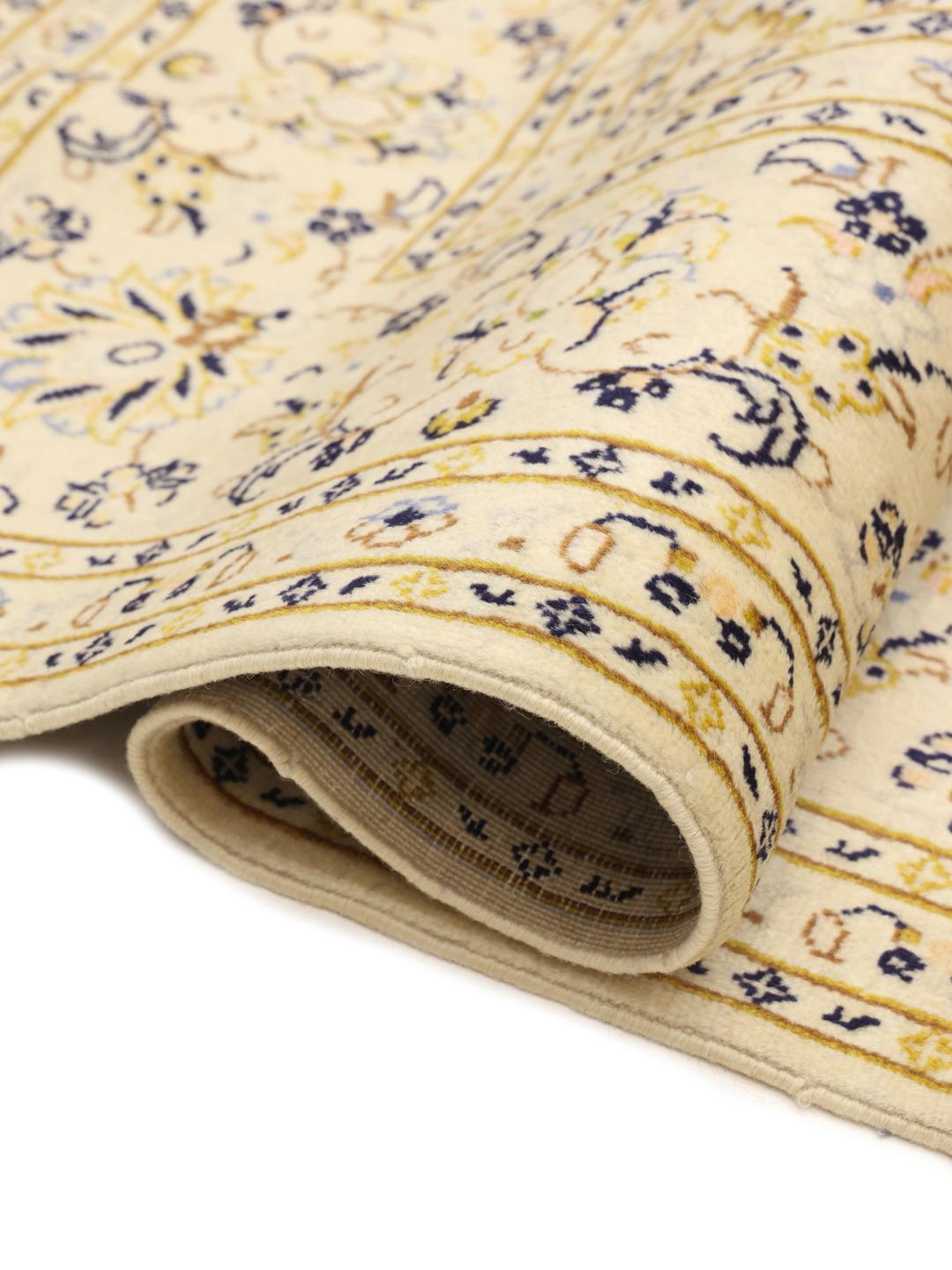 Hand-knotted Keshan rug from the Middle East featuring a beige floral design.