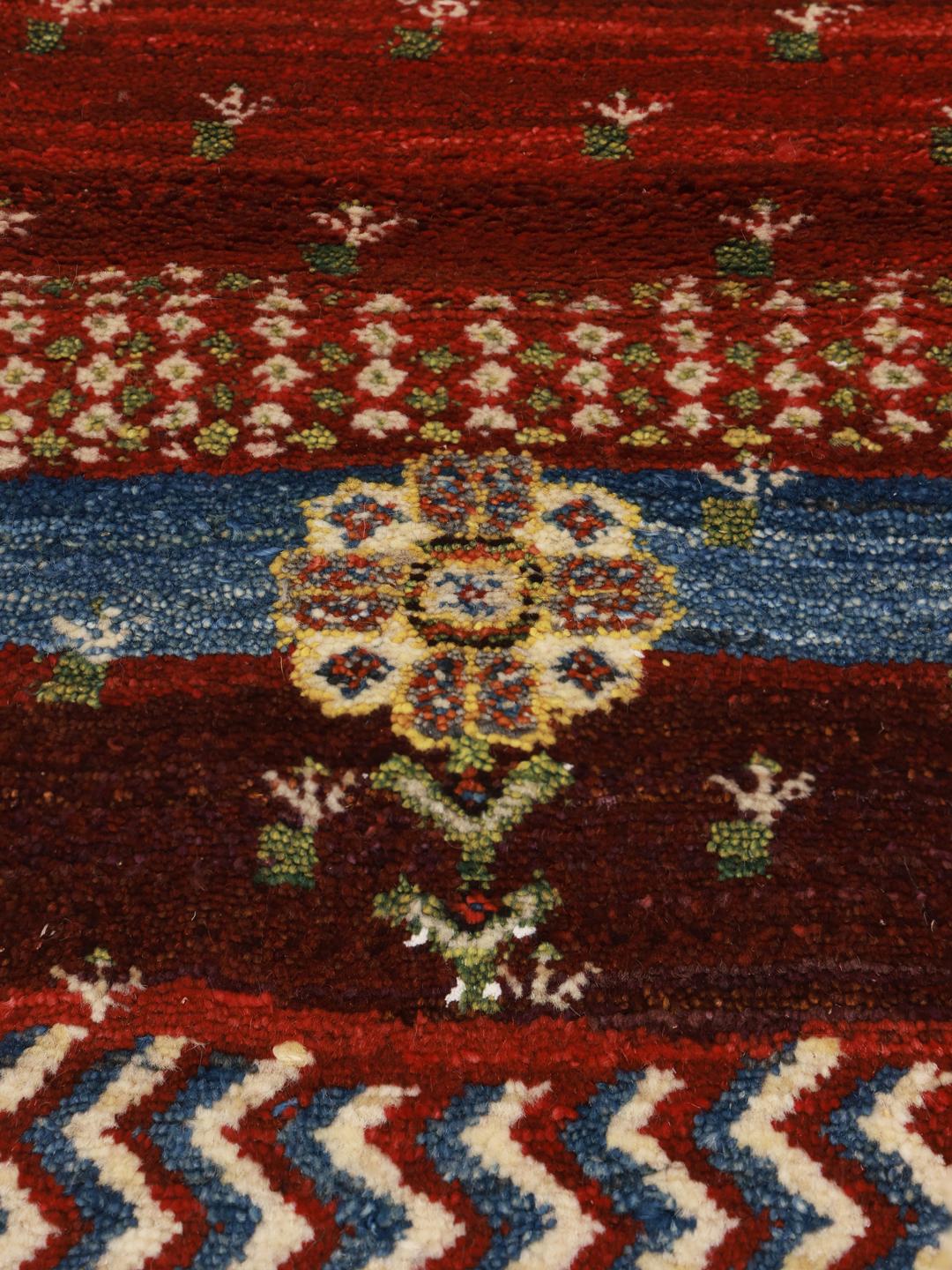 Hand-knotted Shabargan rug from the Middle East in vibrant red with pictorial motifs.
