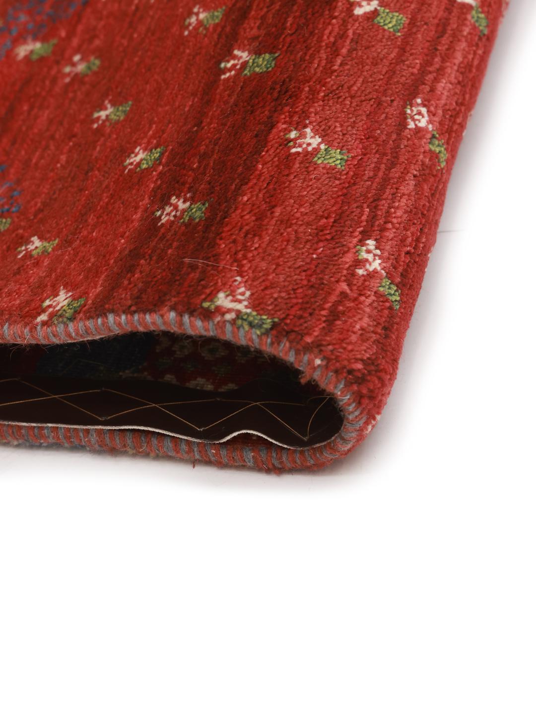 Hand-knotted Shabargan rug from the Middle East in vibrant red with pictorial motifs.