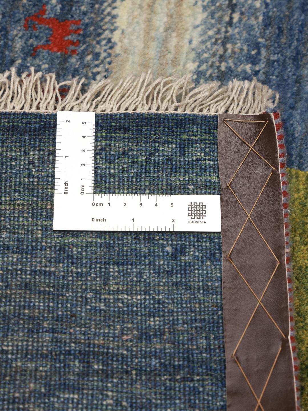Hand-knotted Gabbeh rug from the Middle East in blue with organic central motif