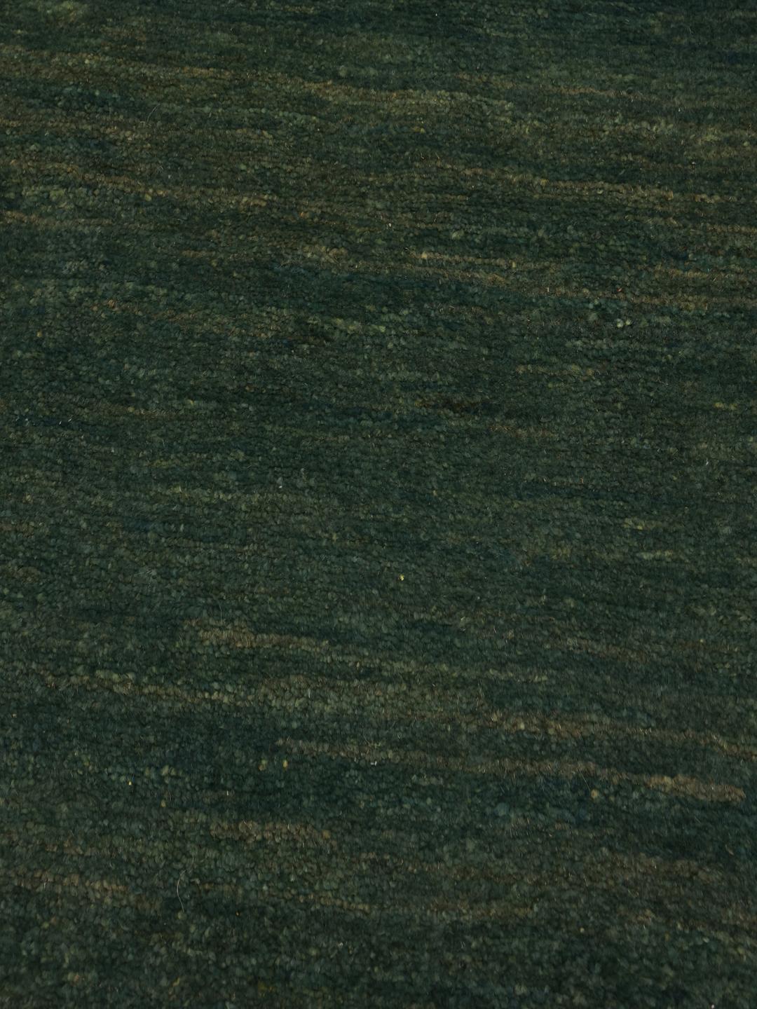 Hand-knotted Gabbeh rug in dark green, originating from the Middle East.