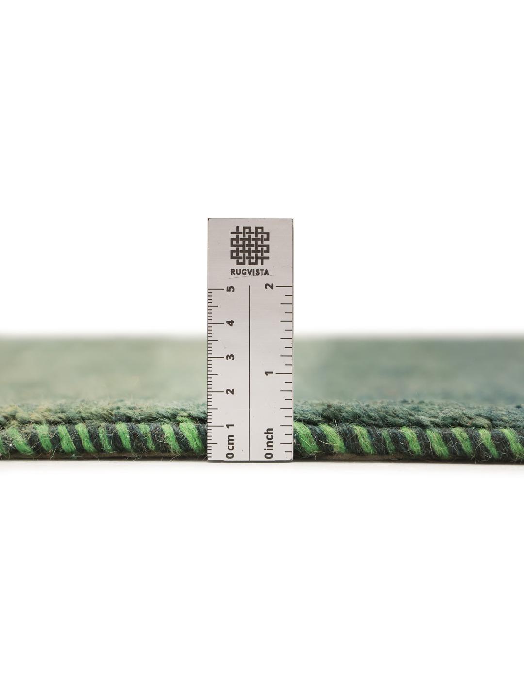 Hand-knotted Gabbeh rug in dark green, originating from the Middle East.