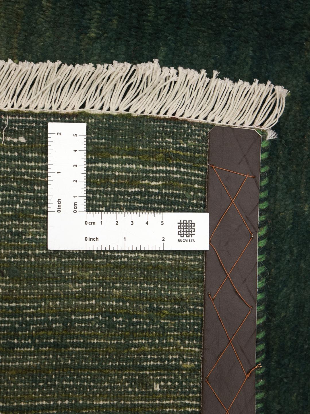 Hand-knotted Gabbeh rug in dark green, originating from the Middle East.