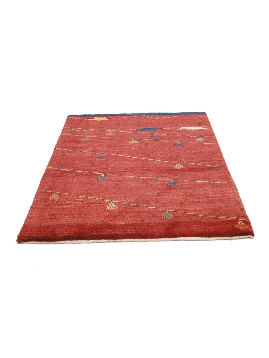 Hand-knotted Gabbeh rug from the Middle East in a deep red colour
