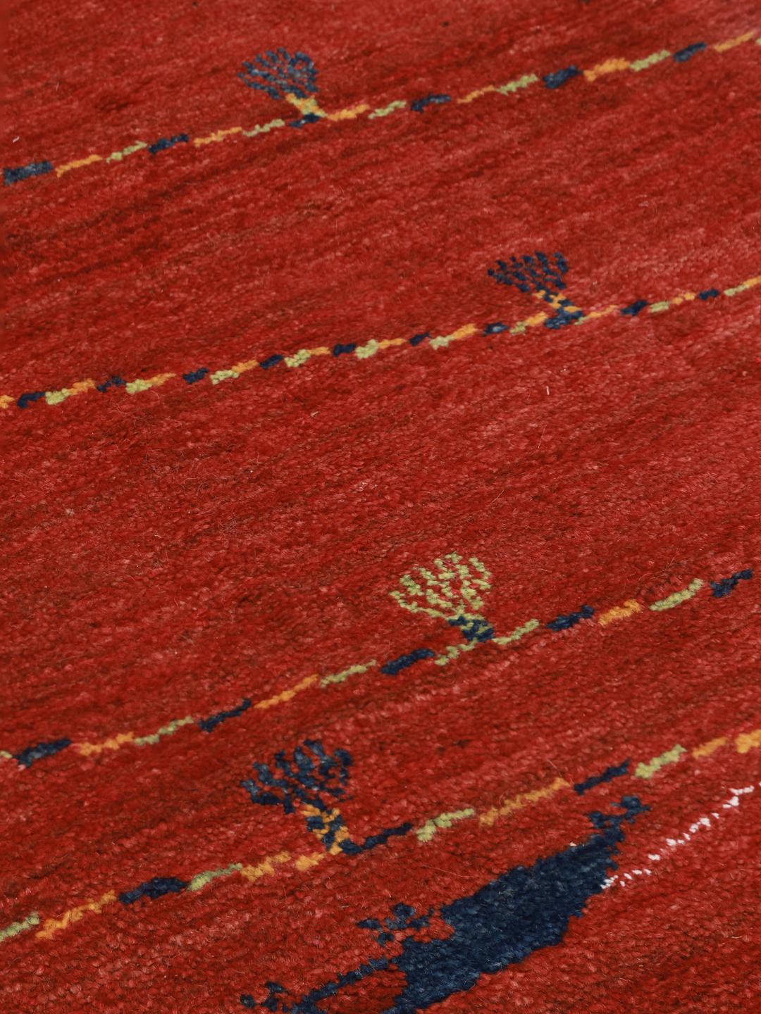 Hand-knotted Gabbeh rug from the Middle East in a deep red colour