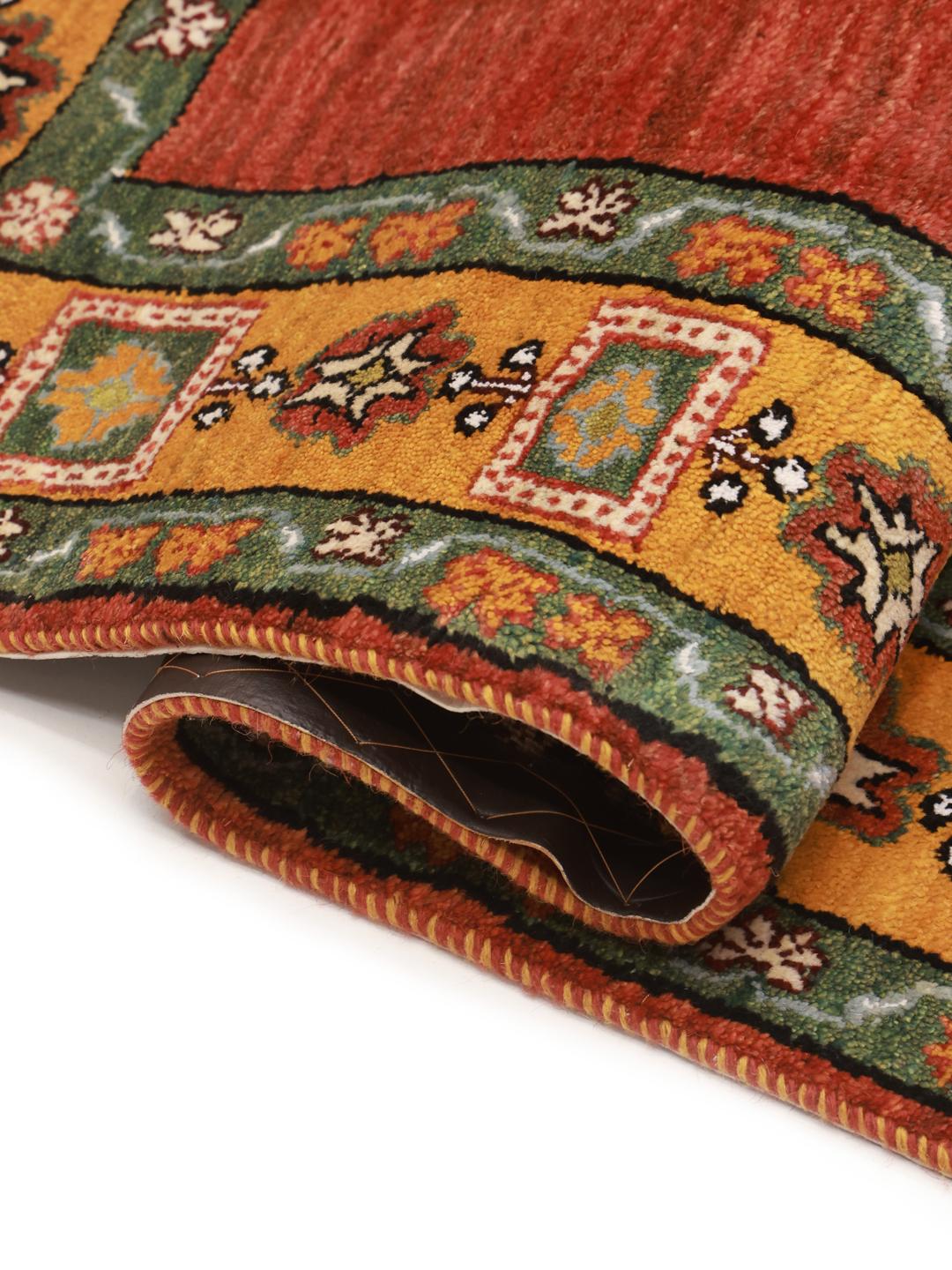 Hand-knotted Gabbeh rug with a red field and decorative border from the Middle East