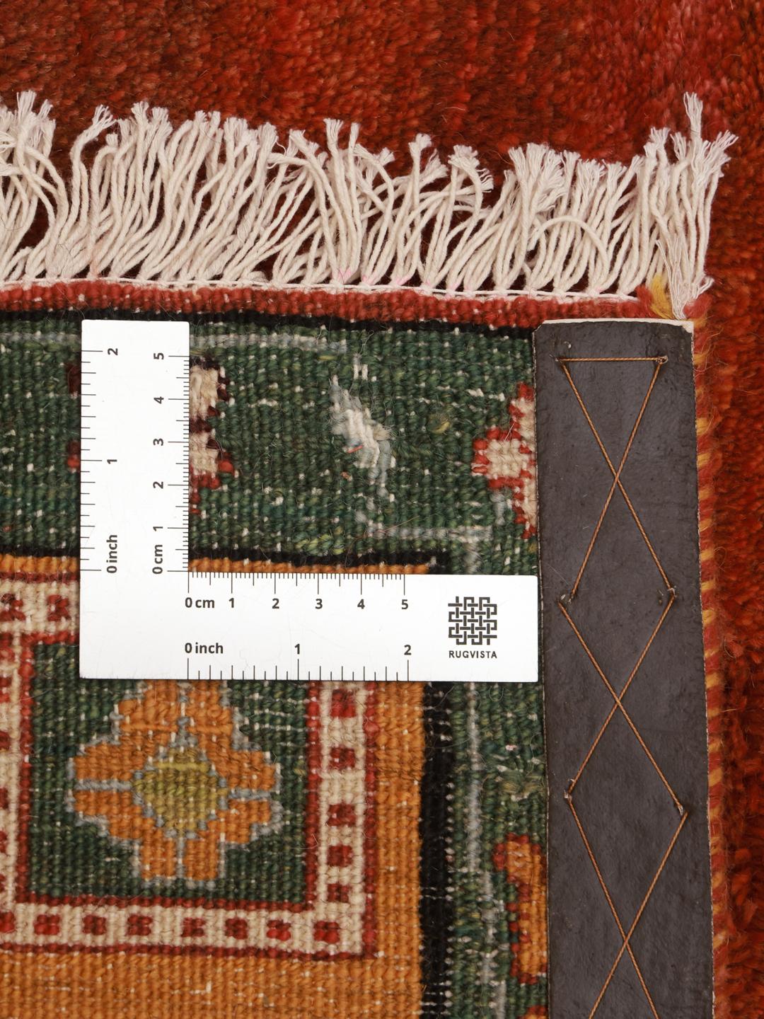 Hand-knotted Gabbeh rug with a red field and decorative border from the Middle East