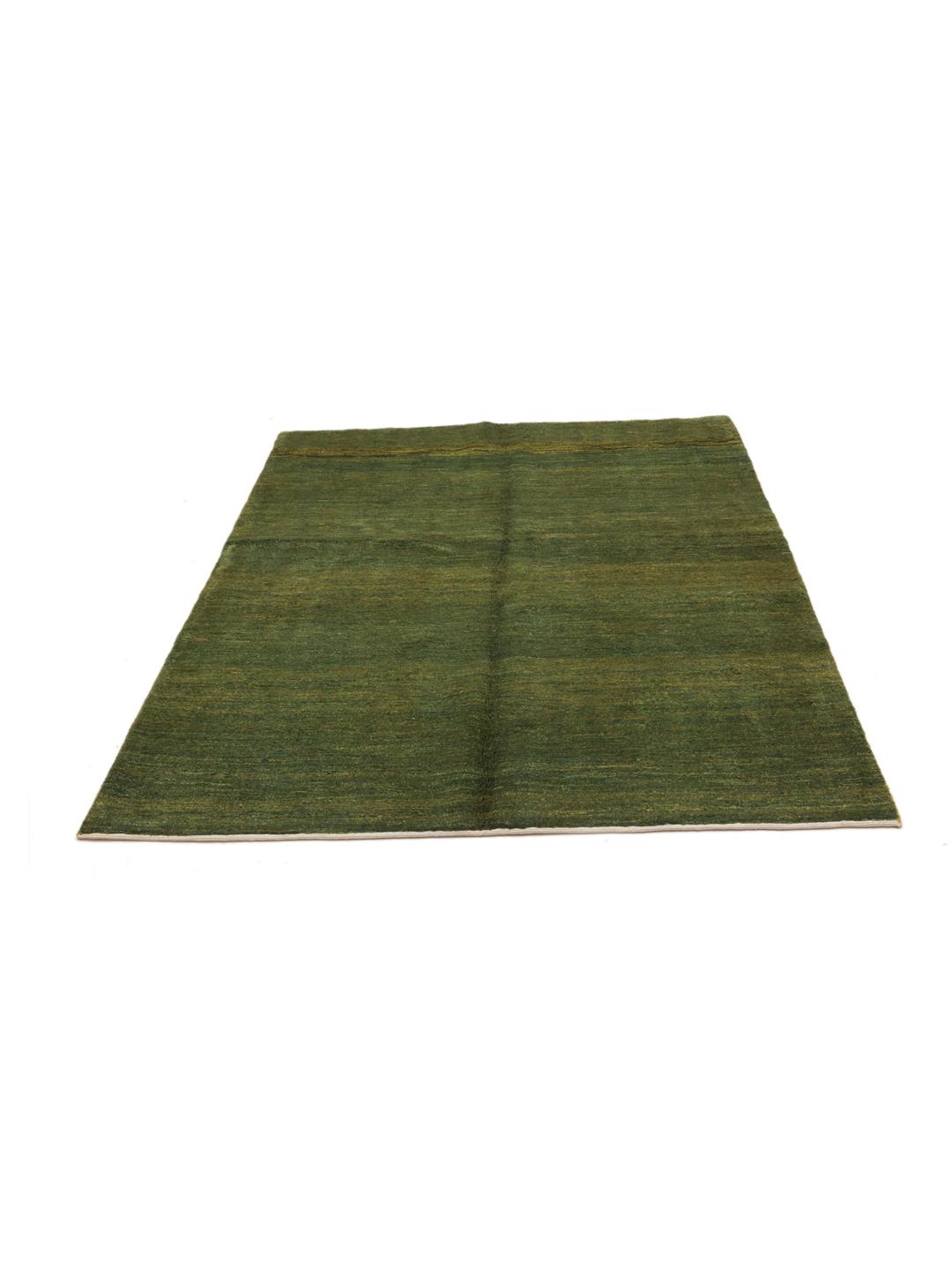 Hand-knotted green wool rug from the Middle East