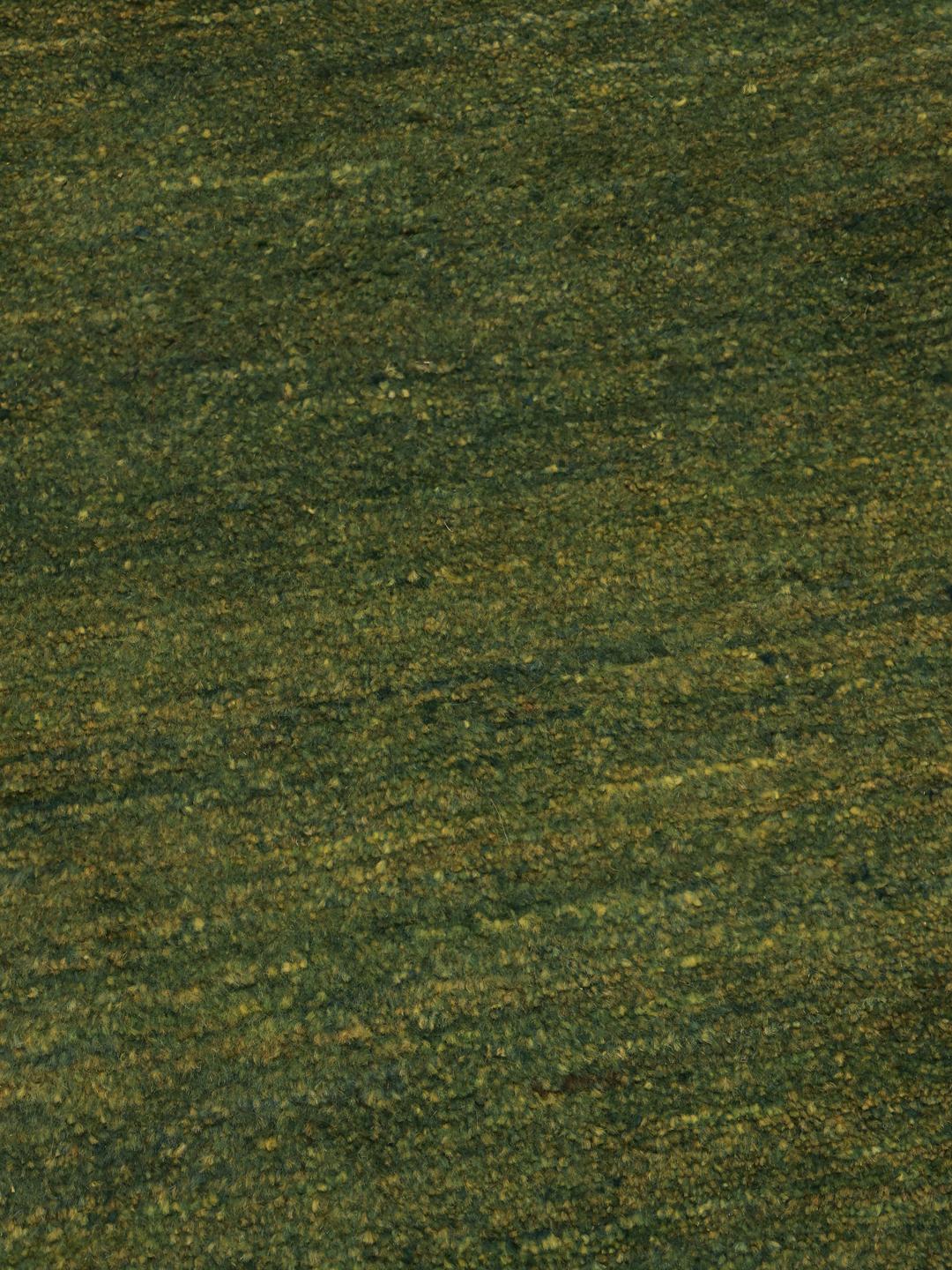 Hand-knotted green wool rug from the Middle East