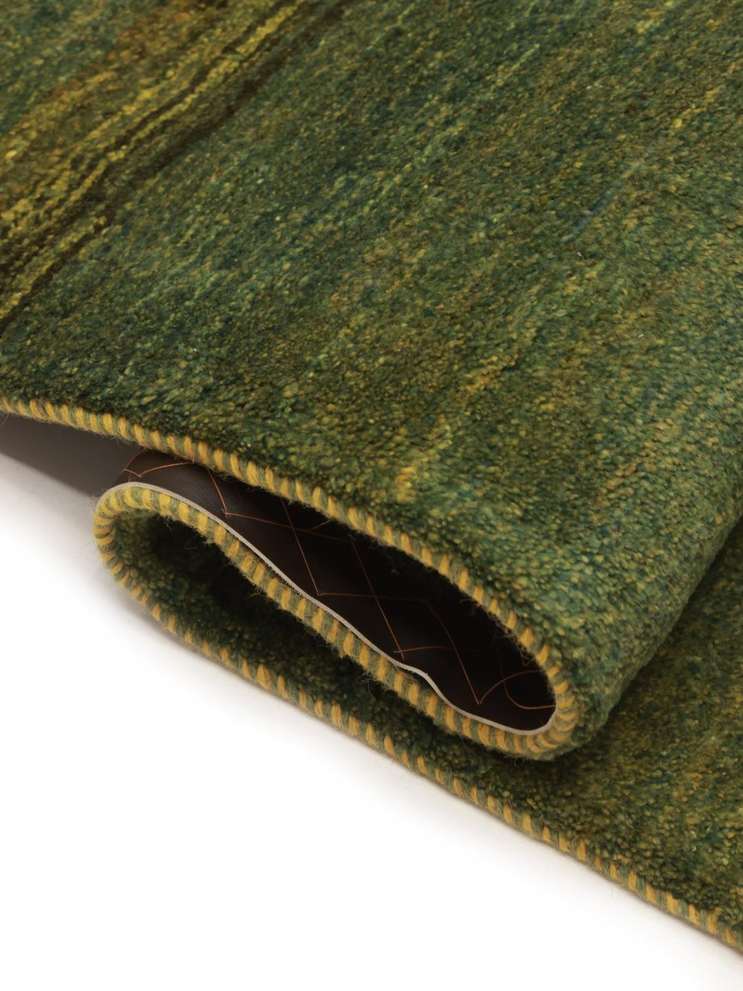 Hand-knotted green wool rug from the Middle East