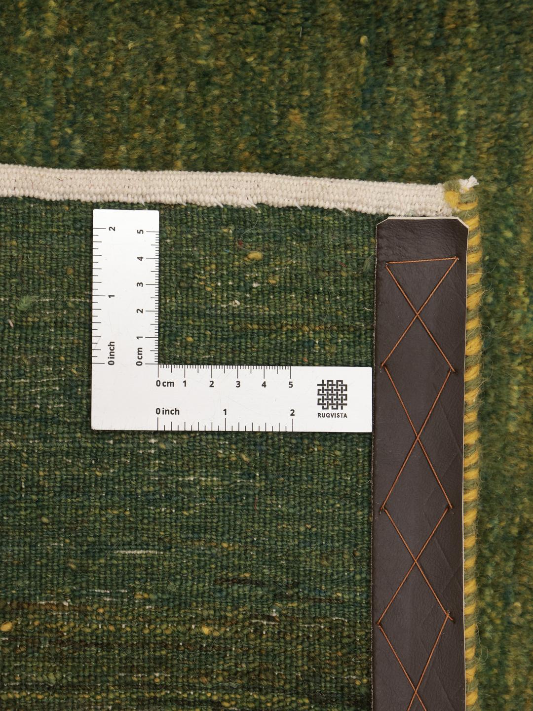 Hand-knotted green wool rug from the Middle East