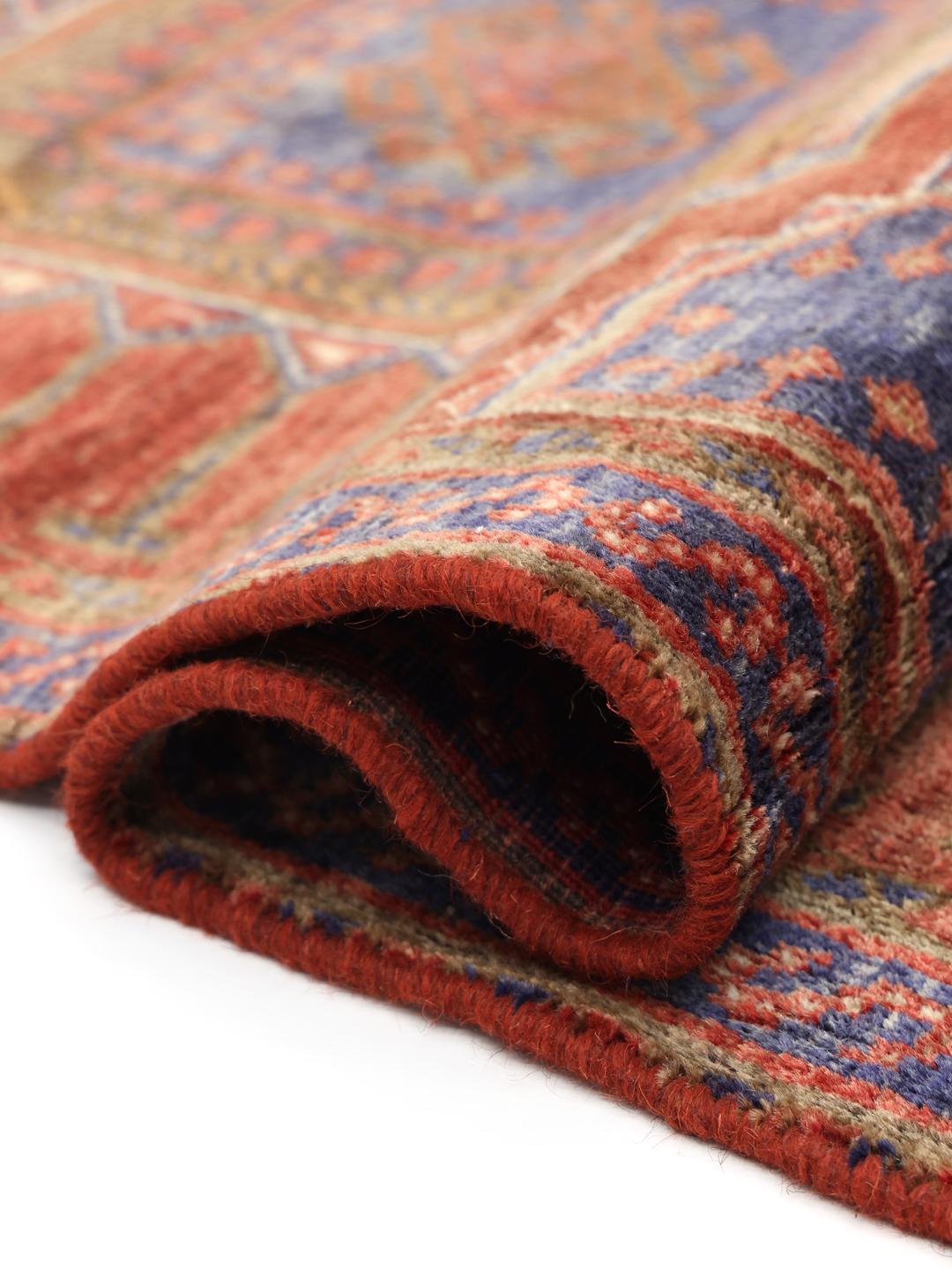 Hand-knotted red rug from the Middle East with a unique patina finish
