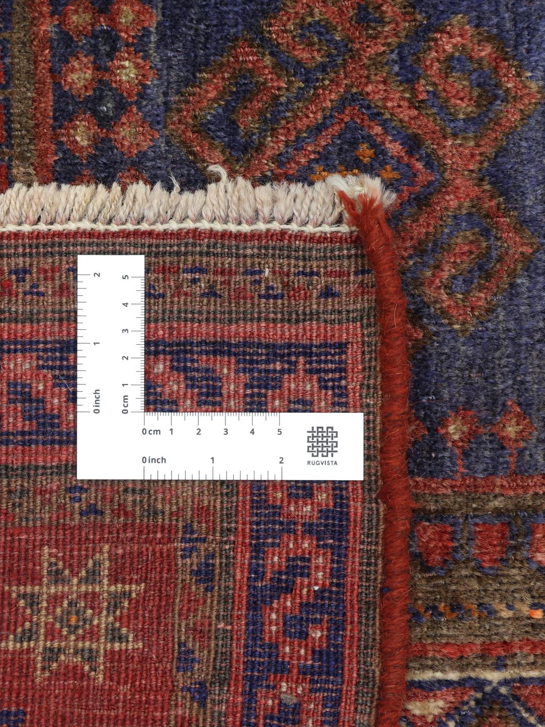 Hand-knotted red rug from the Middle East with a unique patina finish
