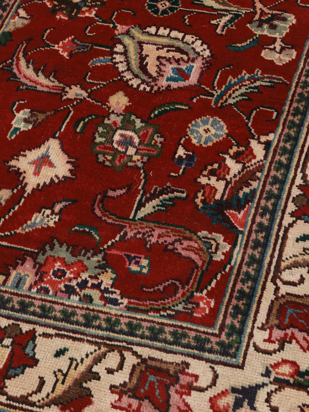 Hand-knotted Tabriz runner from the Middle East in deep red and beige tones.