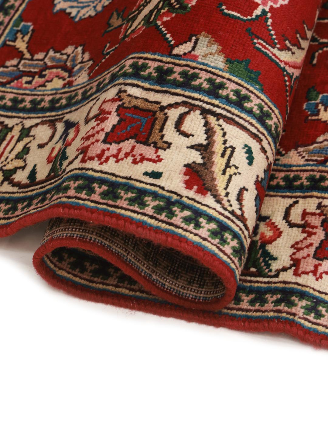 Hand-knotted Tabriz runner from the Middle East in deep red and beige tones.