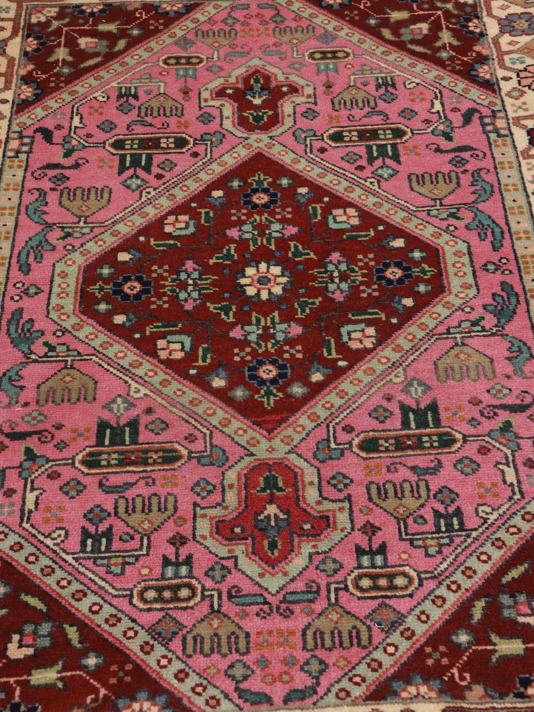 Hand-knotted Tabriz rug with a red and pink medallion design from the Middle East