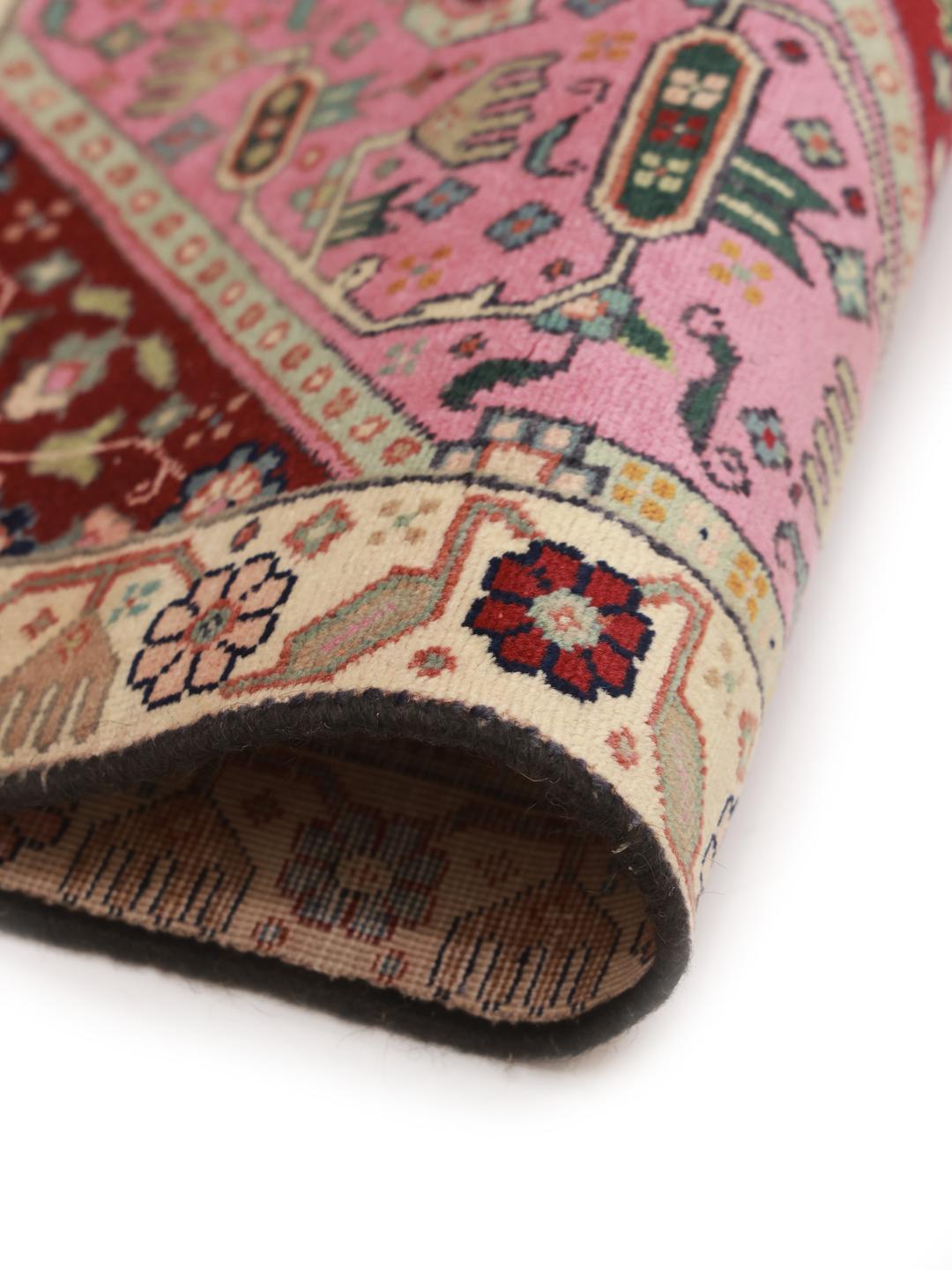 Hand-knotted Tabriz rug with a red and pink medallion design from the Middle East