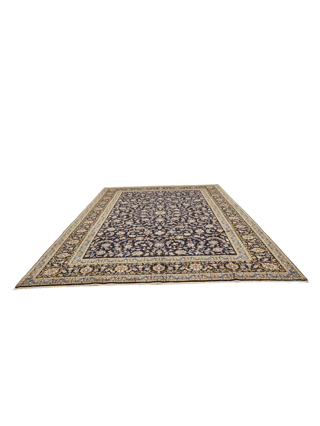 A large, rectangular hand-knotted Keshan rug from the Middle East featuring a floral pattern in dark-blue and cream tones.