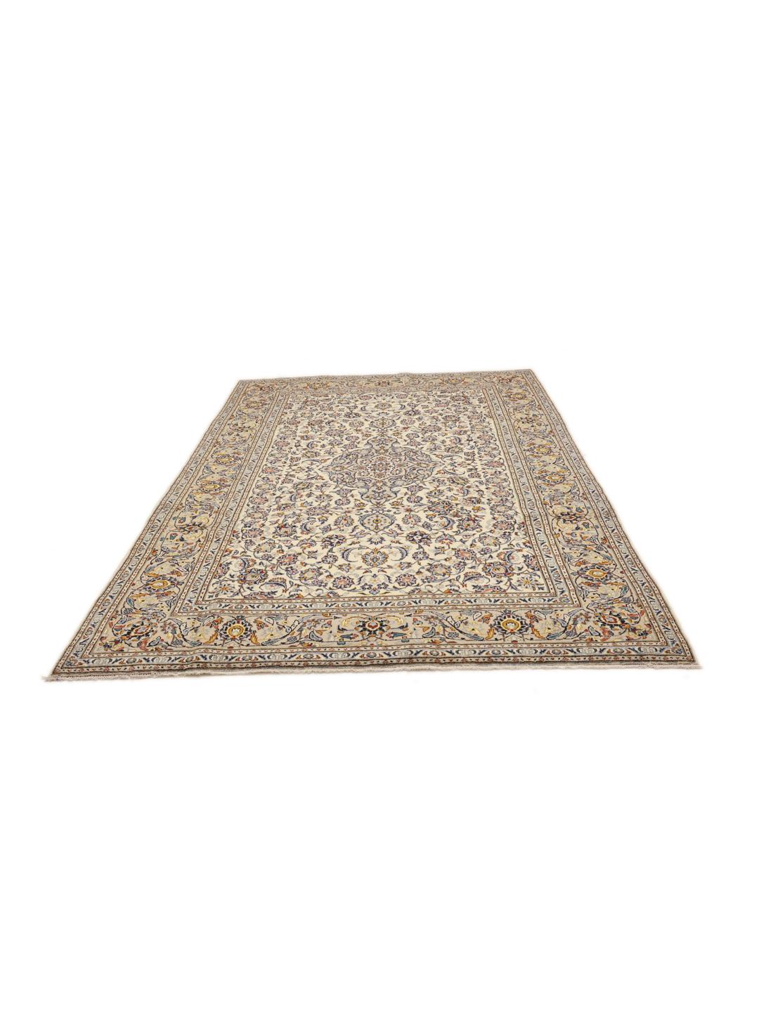 A rectangular hand-knotted Keshan rug from the Middle East in beige tones with floral patterns.
