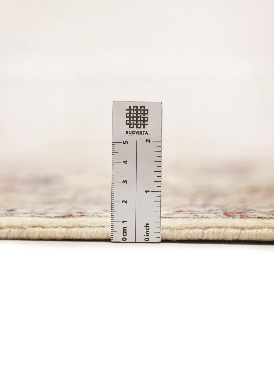 A rectangular hand-knotted Keshan rug from the Middle East in beige tones with floral patterns.