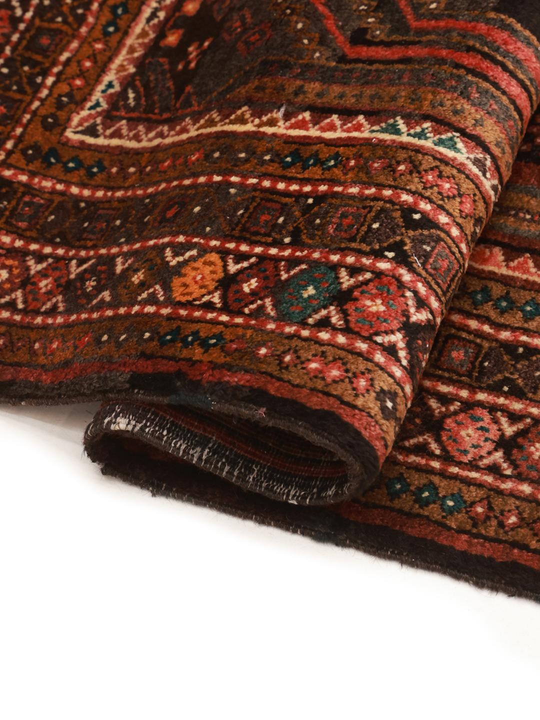 Hand-knotted Middle Eastern rug in dark-red and black with tribal patterns