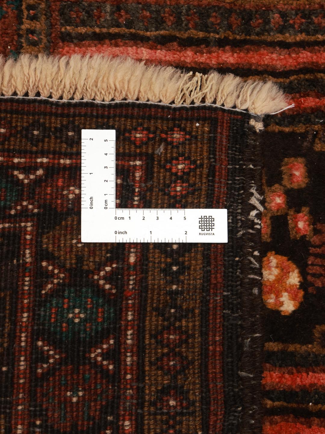 Hand-knotted Middle Eastern rug in dark-red and black with tribal patterns