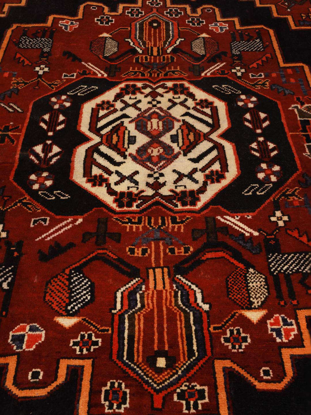Hand-knotted Hamadan rug from the Middle East in dark red and black with geometric medallion patterns