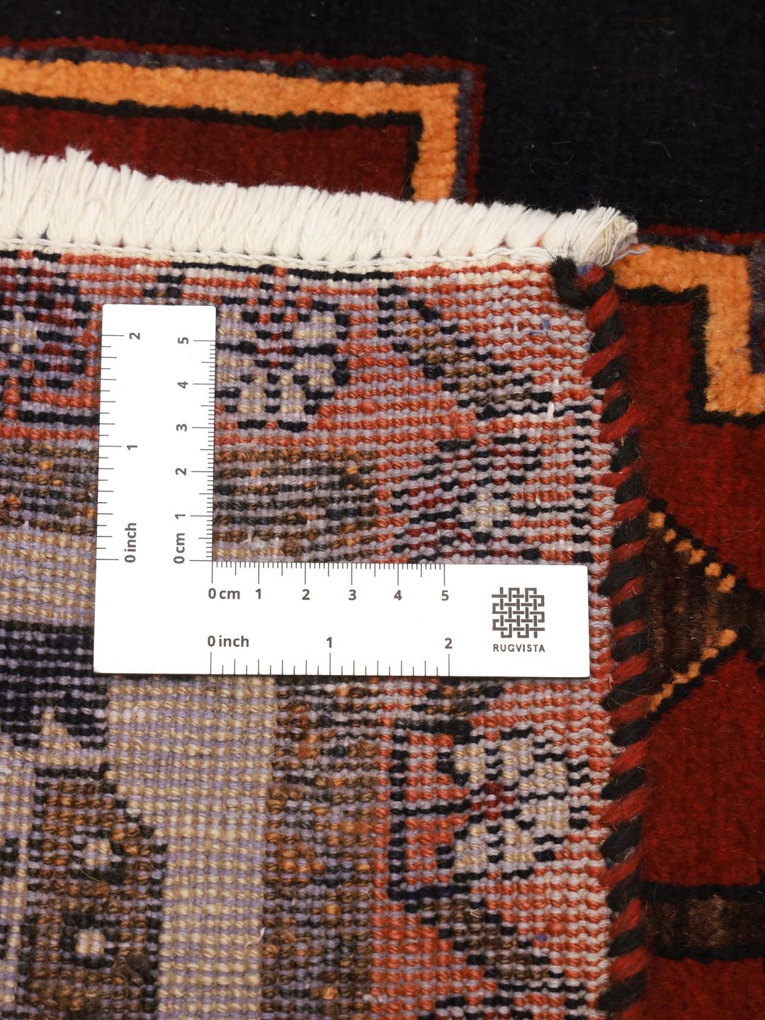 Hand-knotted Hamadan rug from the Middle East in dark red and black with geometric medallion patterns