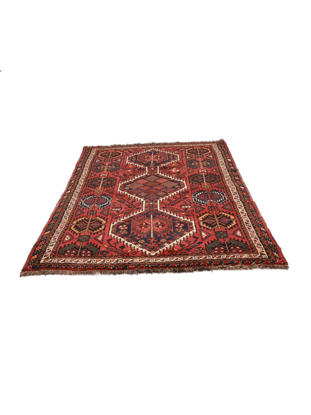 Hand-knotted Shiraz rug from the Middle East featuring a vibrant red field and tribal geometric patterns.