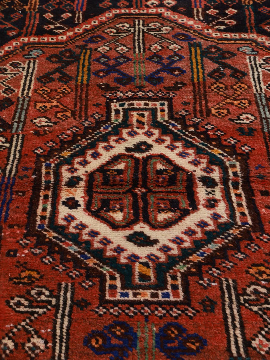 Hand-knotted Shiraz rug from the Middle East in dark-red and blue tones