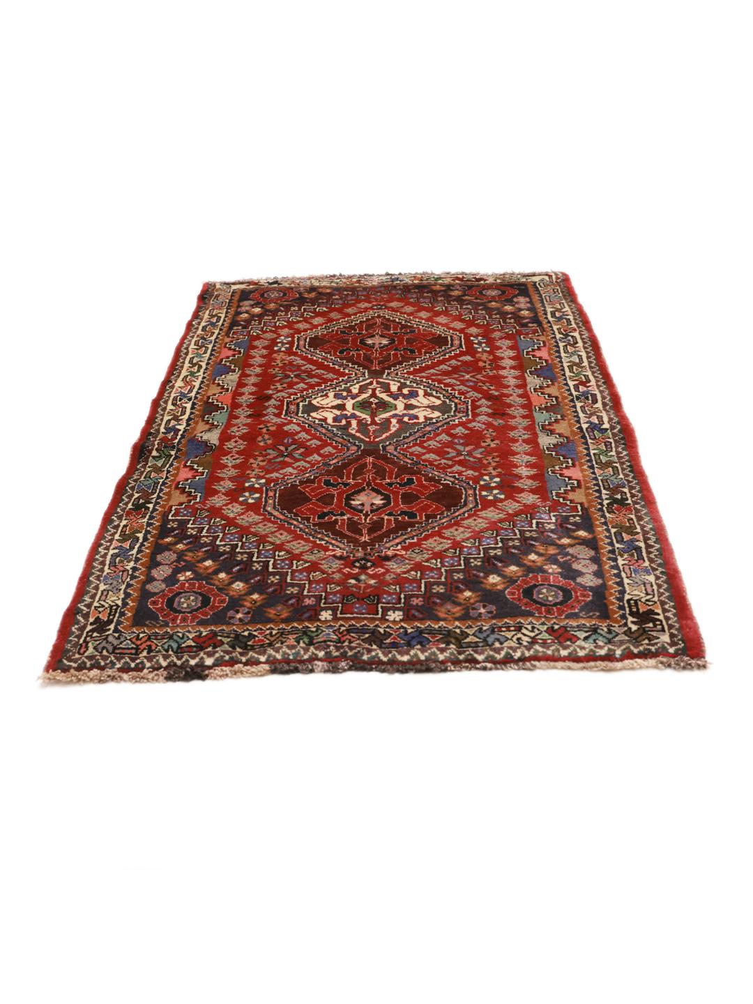 Hand-knotted red Ghashghai rug featuring tribal geometric motifs