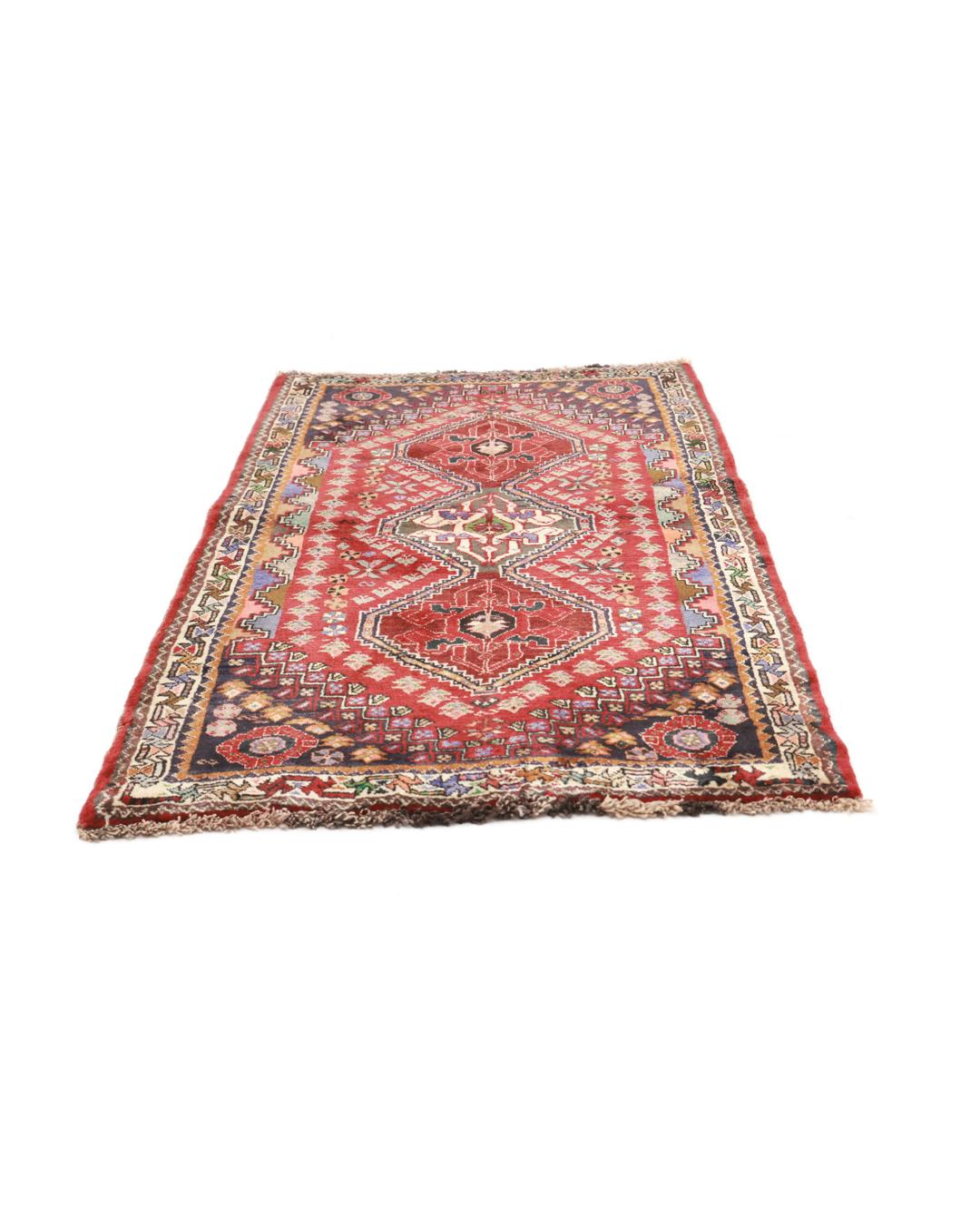 Hand-knotted red Ghashghai rug featuring tribal geometric motifs