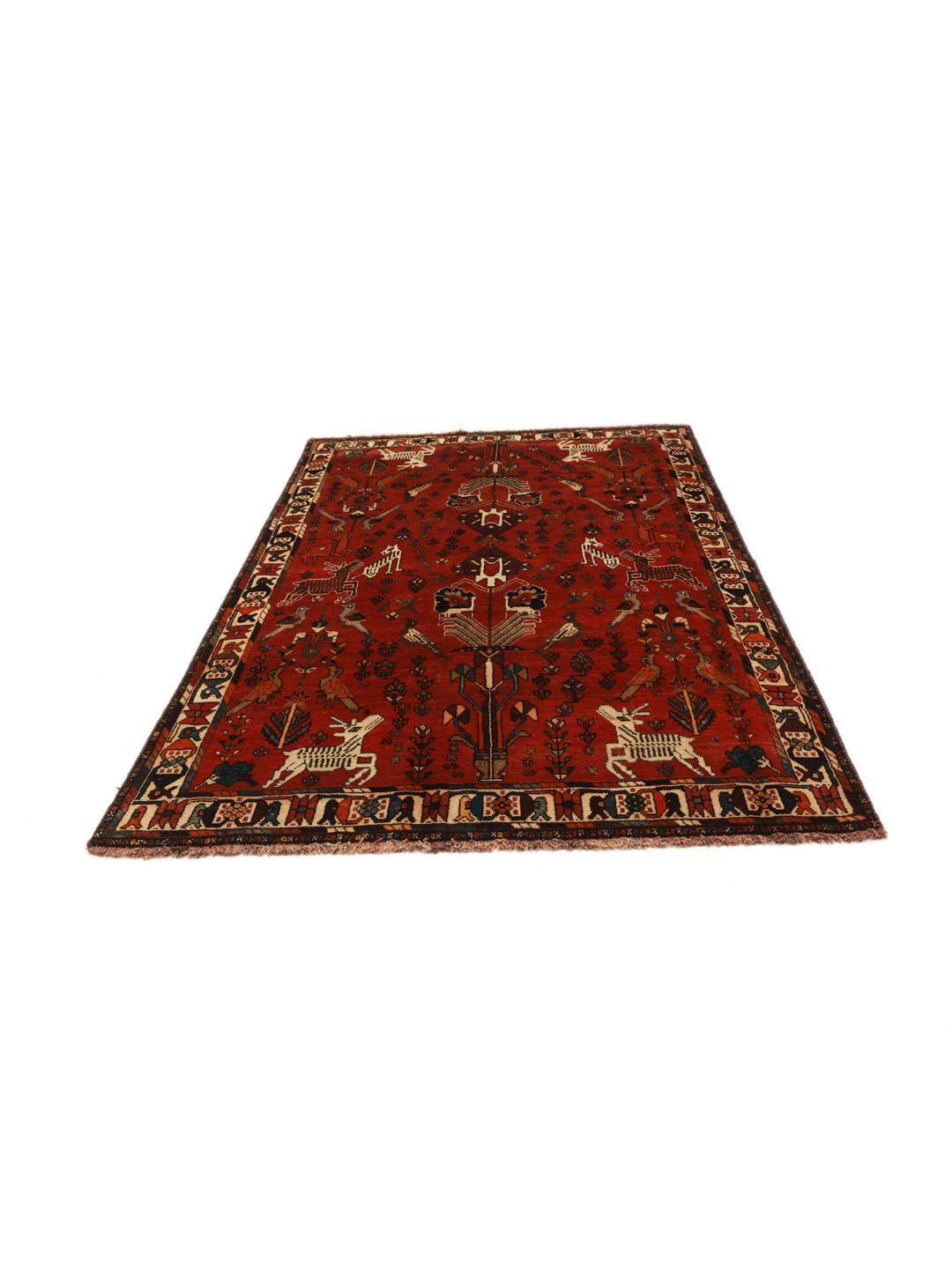 A unique hand-knotted Ghashghai rug from the Middle East with a vibrant red field and animal motifs.