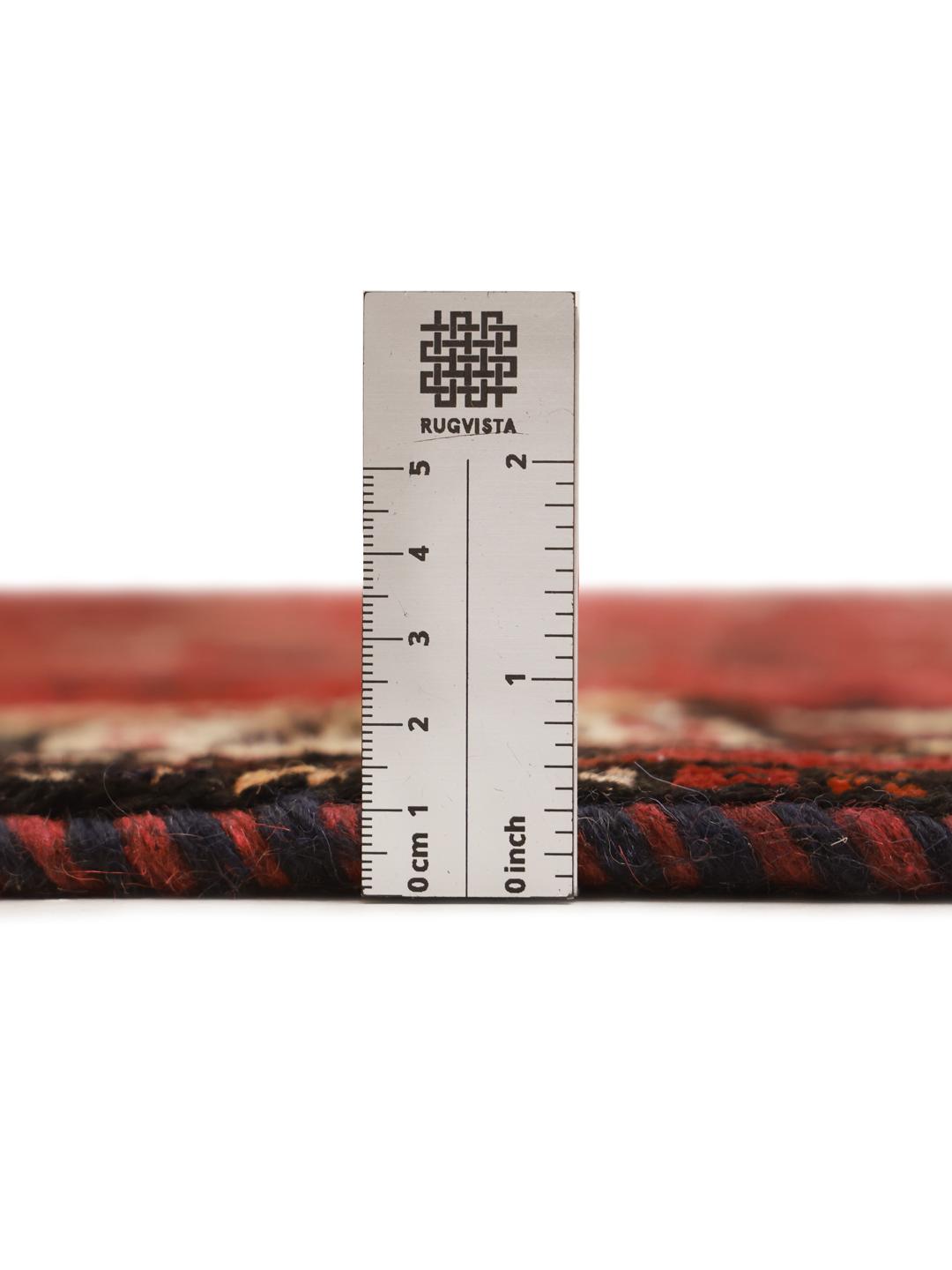 A unique hand-knotted Ghashghai rug from the Middle East with a vibrant red field and animal motifs.