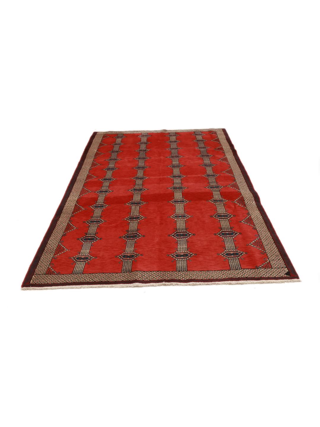 A hand-knotted Shiraz rug from the Middle East featuring a red field with geometric motifs.