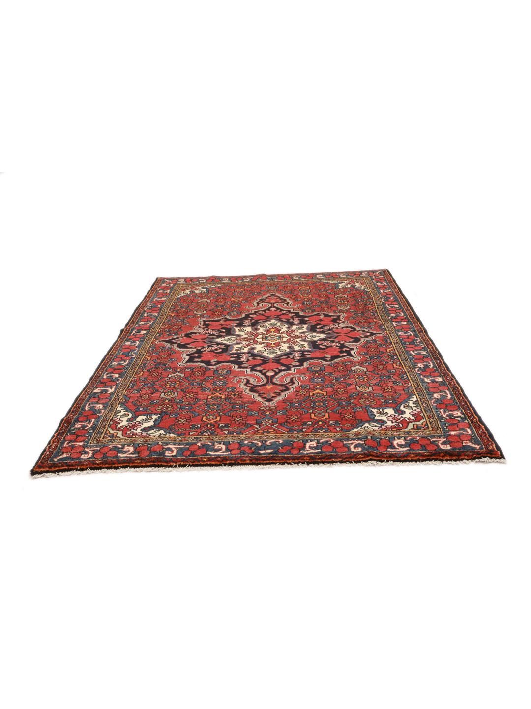 A hand-knotted Hosseinabad wool rug from the Middle East featuring a red field and central medallion.