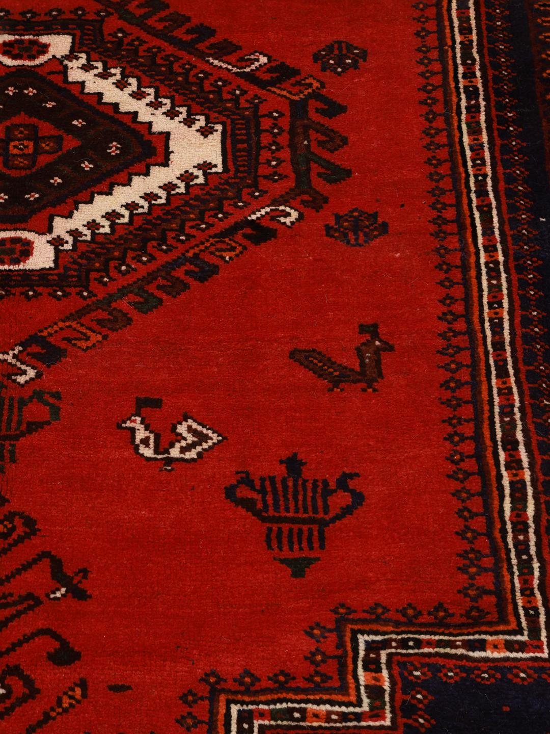 Hand-knotted Ghashghai rug with red and blue tribal patterns from the Middle East