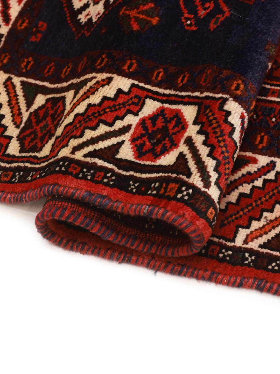 Hand-knotted Ghashghai rug with red and blue tribal patterns from the Middle East