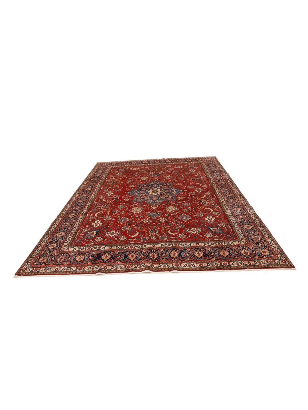 A beautiful, one-of-a-kind hand-knotted Sarough rug from the Middle East featuring a vibrant red field with intricate blue and cream floral motifs.