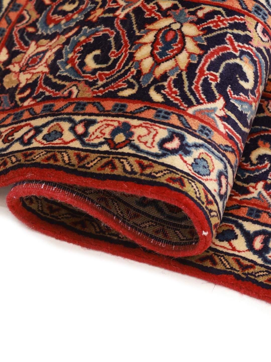 A beautiful, one-of-a-kind hand-knotted Sarough rug from the Middle East featuring a vibrant red field with intricate blue and cream floral motifs.